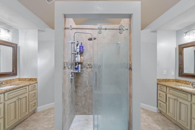 bathroom with vanity and a shower with door