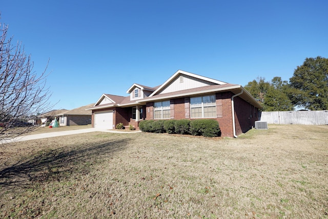 single story home featuring a front yard, central AC unit, and a garage