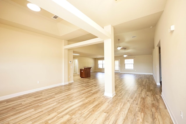 spare room featuring a towering ceiling, light hardwood / wood-style floors, and ceiling fan