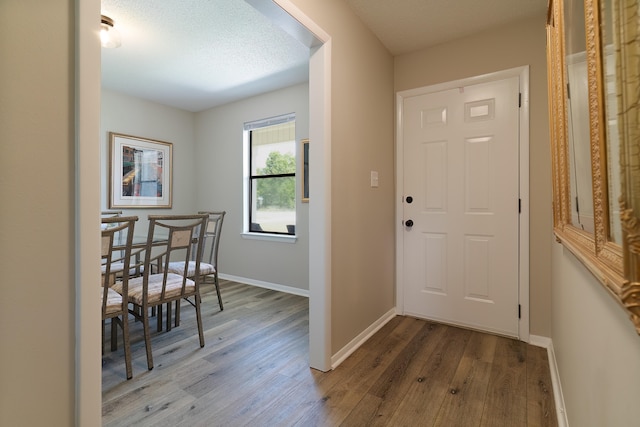 entryway featuring a textured ceiling and hardwood / wood-style flooring