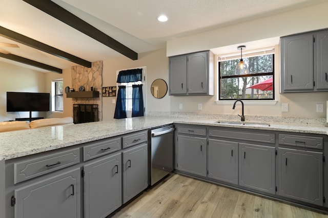 kitchen with kitchen peninsula, stainless steel dishwasher, and gray cabinetry