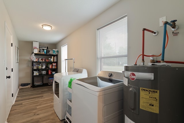 laundry area with electric water heater, wood-type flooring, and independent washer and dryer