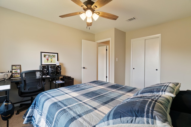 carpeted bedroom with ceiling fan and a closet