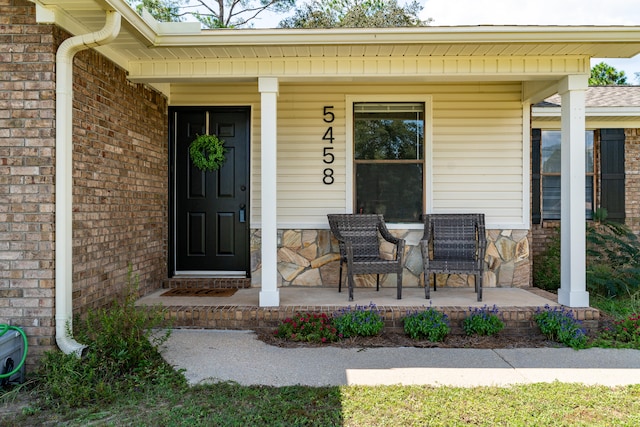 view of exterior entry with covered porch