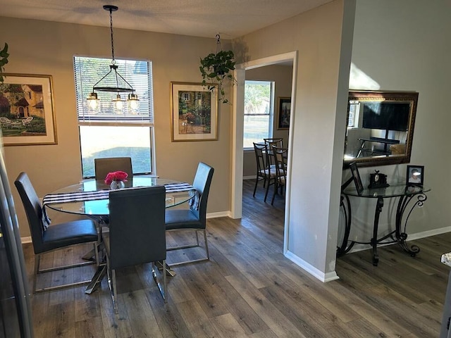 dining area featuring a chandelier and dark wood-type flooring