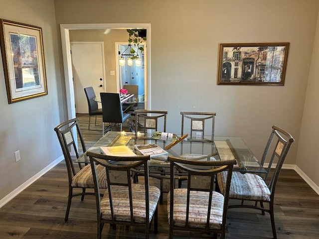 dining area with dark hardwood / wood-style flooring