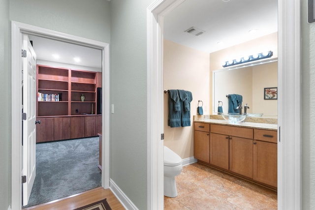 bathroom featuring vanity and toilet