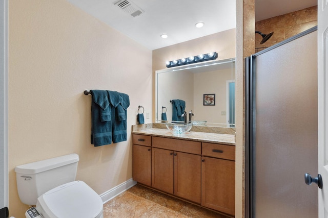 bathroom featuring a shower with door, vanity, and toilet