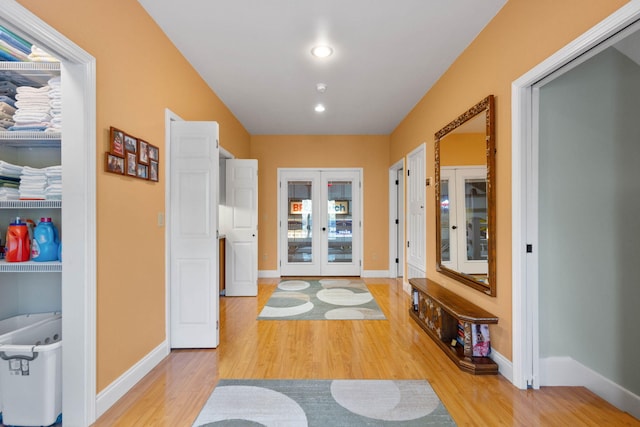 corridor featuring wood-type flooring and french doors