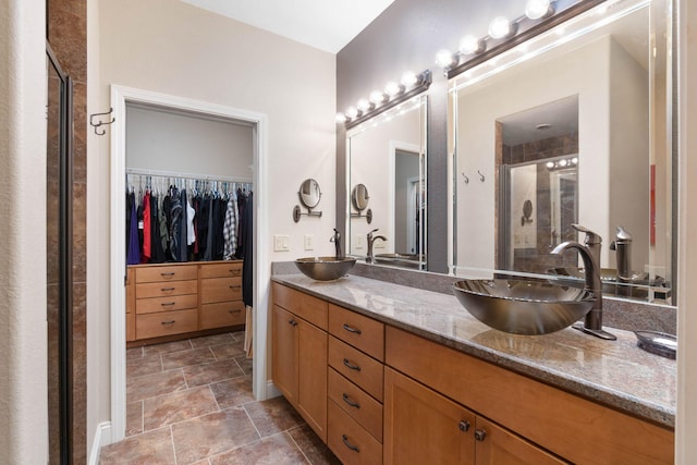 bathroom with walk in shower and vanity