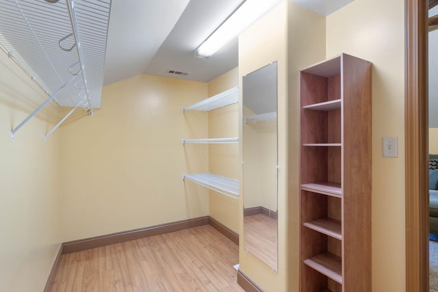 walk in closet with light wood-type flooring