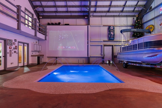 view of pool with pool water feature and a patio