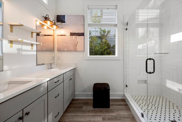 bathroom featuring vanity, a shower with shower door, and hardwood / wood-style flooring