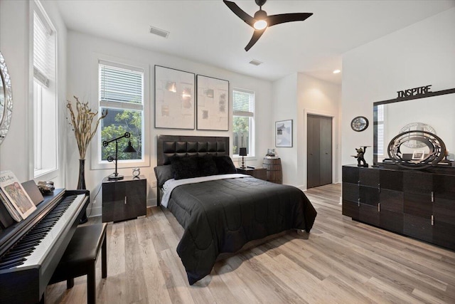 bedroom with light wood-type flooring and ceiling fan