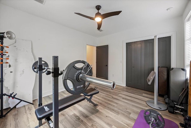 exercise area featuring ceiling fan and light hardwood / wood-style floors