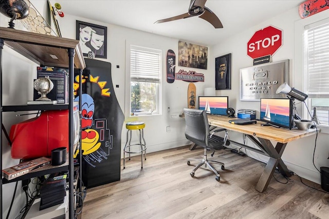 office featuring a wealth of natural light, ceiling fan, and hardwood / wood-style flooring