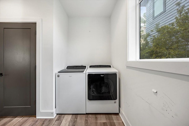 laundry room featuring wood-type flooring and washer and clothes dryer