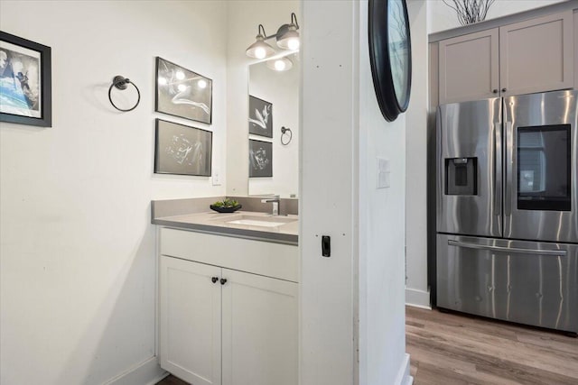 bathroom with hardwood / wood-style flooring and vanity