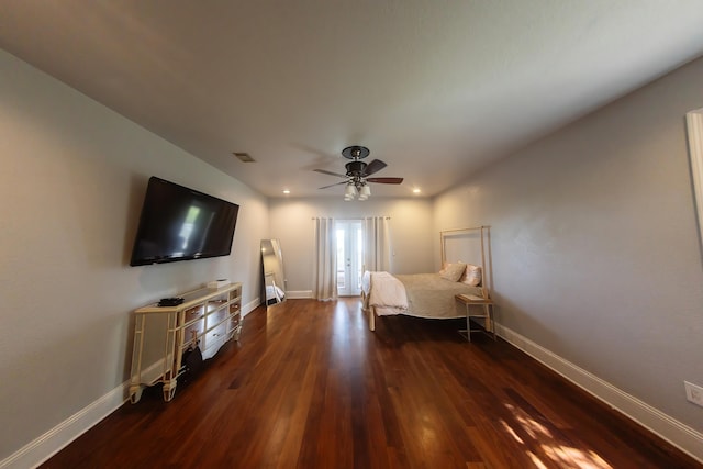 bedroom with dark hardwood / wood-style flooring and ceiling fan