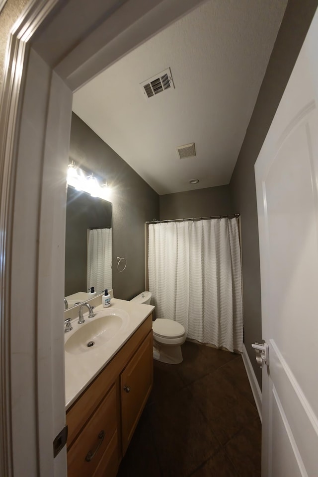 bathroom featuring tile patterned flooring, vanity, toilet, and a shower with curtain