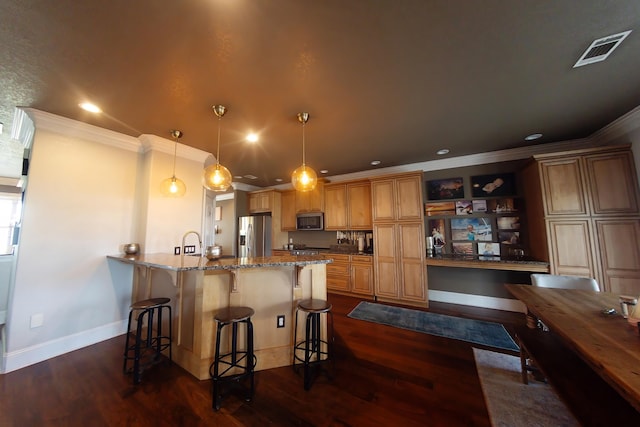 kitchen featuring hanging light fixtures, kitchen peninsula, stainless steel appliances, crown molding, and dark hardwood / wood-style floors