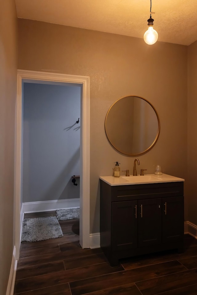 bathroom featuring wood-type flooring, a textured ceiling, and vanity