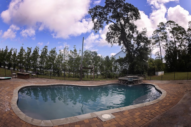 view of pool featuring a patio and an in ground hot tub