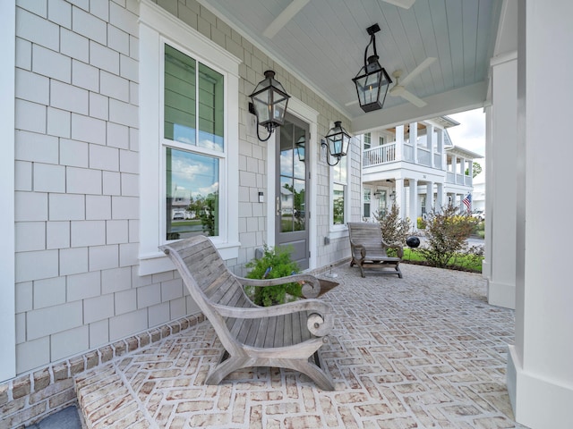 view of patio with ceiling fan and a porch