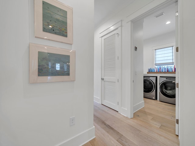 218 White Cottage Rd, Santa Rosa Beach, FL 32459 - hall featuring washing machine and dryer, baseboards, visible vents, and wood finished floors