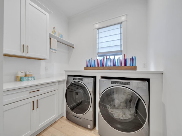 218 White Cottage Rd, Santa Rosa Beach, FL 32459 - laundry room featuring light wood-style flooring, separate washer and dryer, and cabinet space