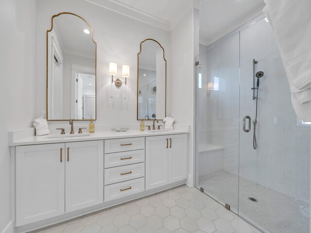 bathroom featuring tile patterned flooring, vanity, a shower with door, and ornamental molding