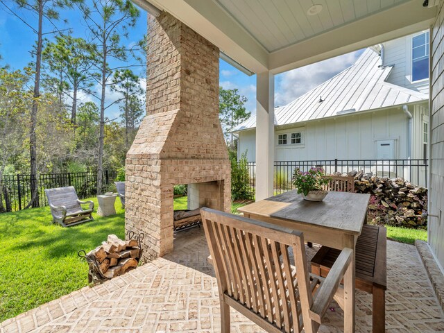 view of patio / terrace with an outdoor brick fireplace