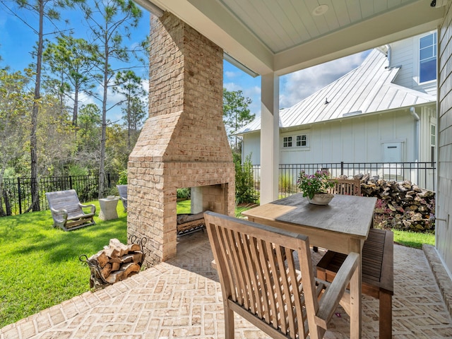 218 White Cottage Rd, Santa Rosa Beach, FL 32459 - view of patio featuring fence, outdoor dining area, and an outdoor brick fireplace