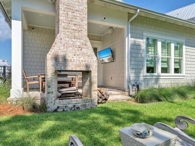 exterior space with a yard and an outdoor fireplace