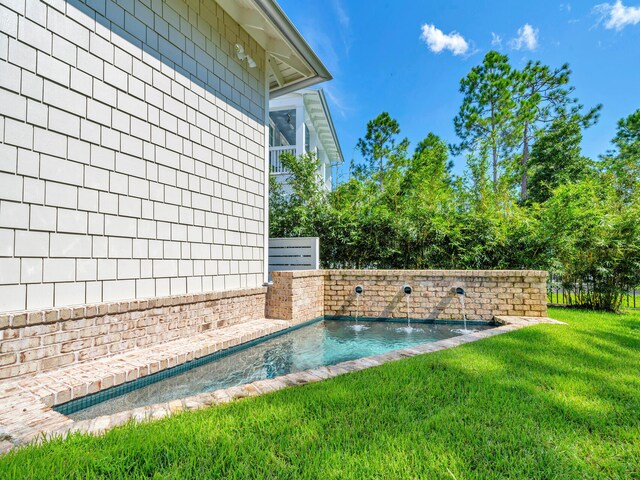 view of swimming pool featuring a lawn