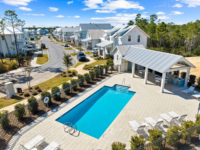 view of pool with a patio and exterior kitchen