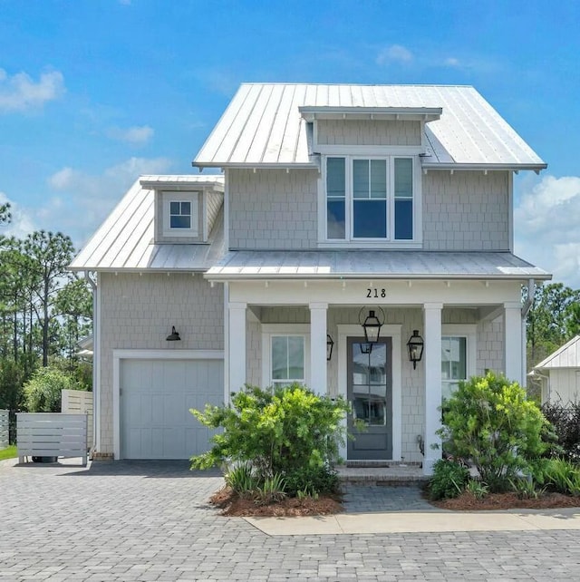 view of front of home with a porch and a garage