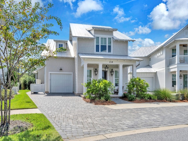 218 White Cottage Rd, Santa Rosa Beach, FL 32459 - view of front of house with metal roof, decorative driveway, and covered porch