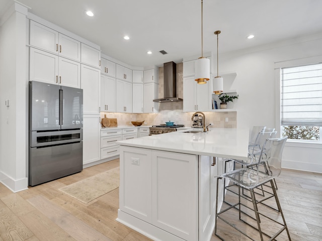 218 White Cottage Rd, Santa Rosa Beach, FL 32459 - kitchen with wall chimney range hood, a peninsula, freestanding refrigerator, stove, and a sink