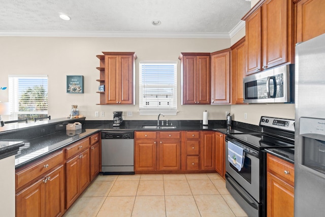 kitchen with appliances with stainless steel finishes, ornamental molding, sink, and light tile patterned floors