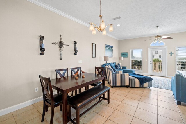 dining space featuring a textured ceiling, ceiling fan with notable chandelier, crown molding, and light tile patterned floors