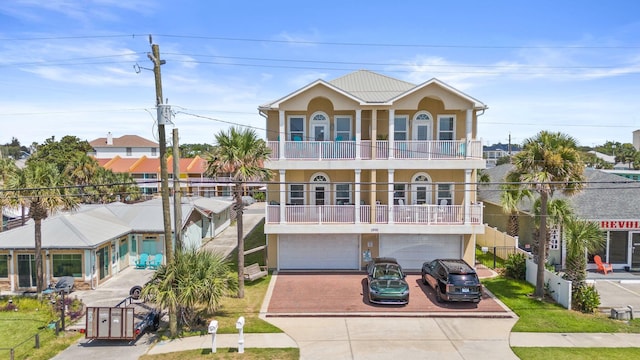 view of front facade featuring a balcony and a garage