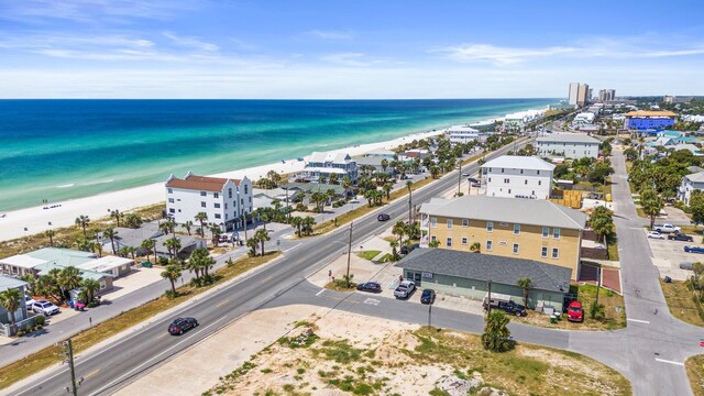 drone / aerial view featuring a water view and a beach view