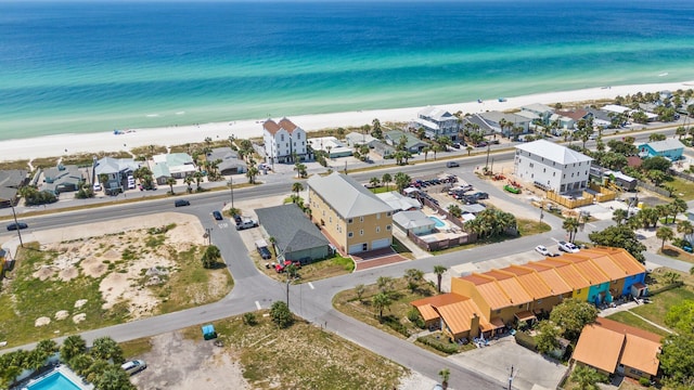 aerial view with a water view and a beach view