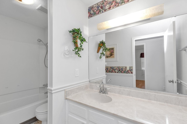 full bathroom featuring a textured ceiling, shower / bathtub combination, vanity, and toilet