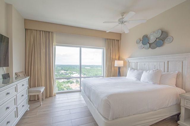 bedroom with ceiling fan and light hardwood / wood-style flooring