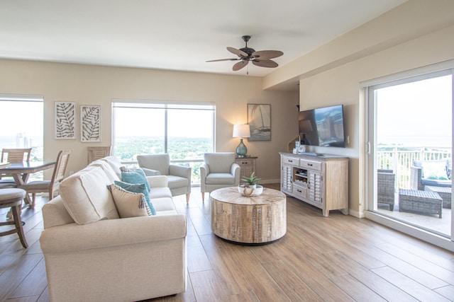 living room featuring ceiling fan and light hardwood / wood-style flooring