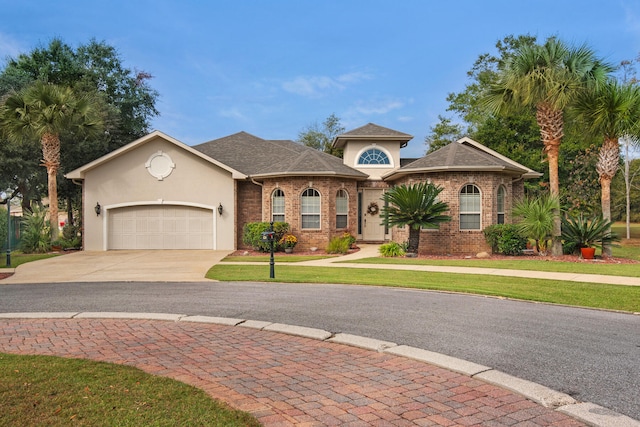 view of front of property featuring a garage and a front yard