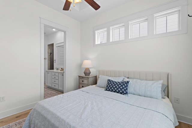 bedroom with light hardwood / wood-style floors, ceiling fan, and ensuite bathroom