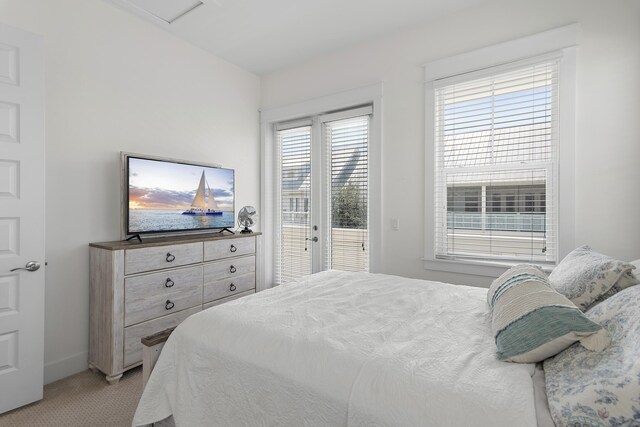 bedroom featuring light colored carpet and access to exterior